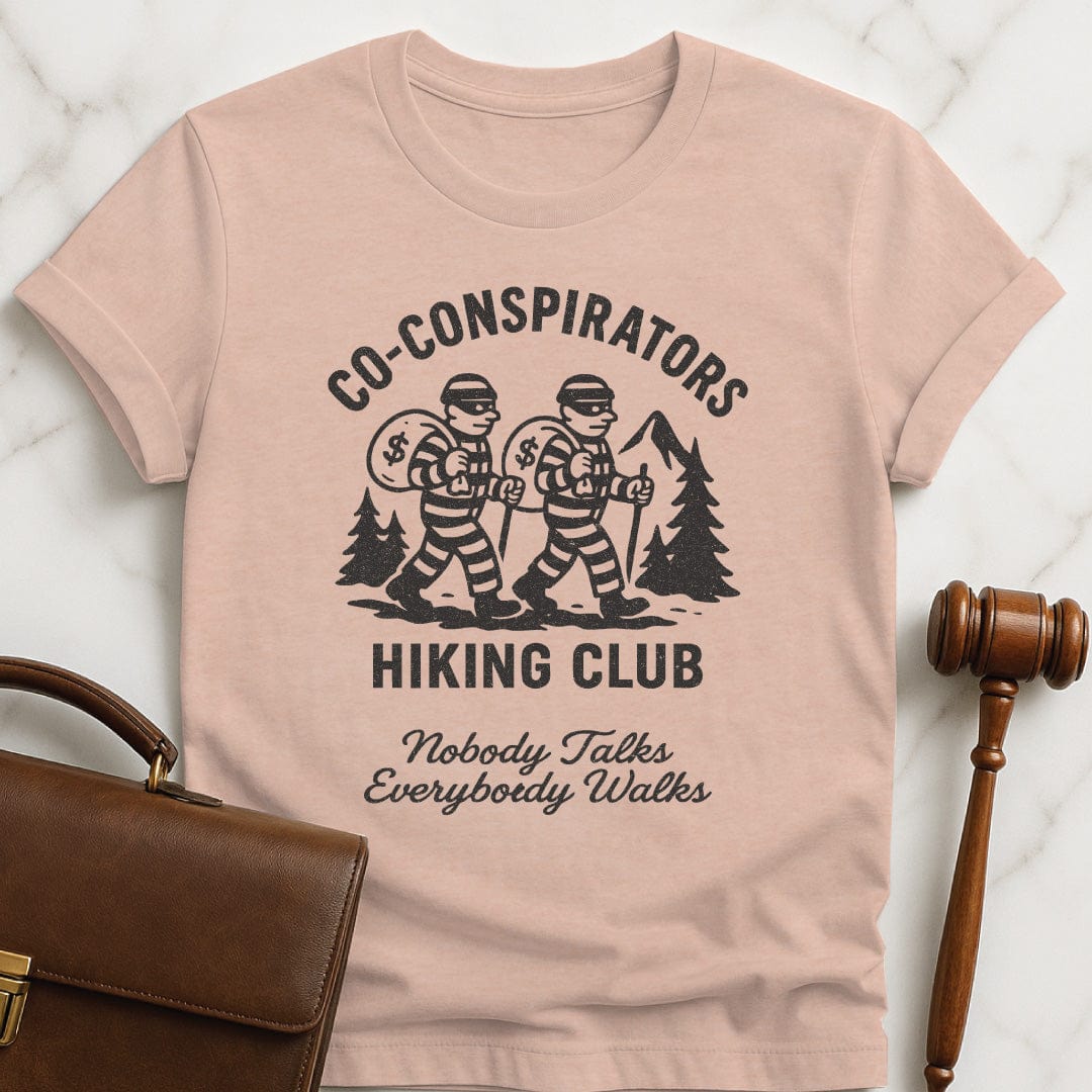 cool law school graduate tee that says Co-Conspirators Hiking Club Nobody Talks Everybody Walks featuring robbers carrying bags of money on a hike in heather peach