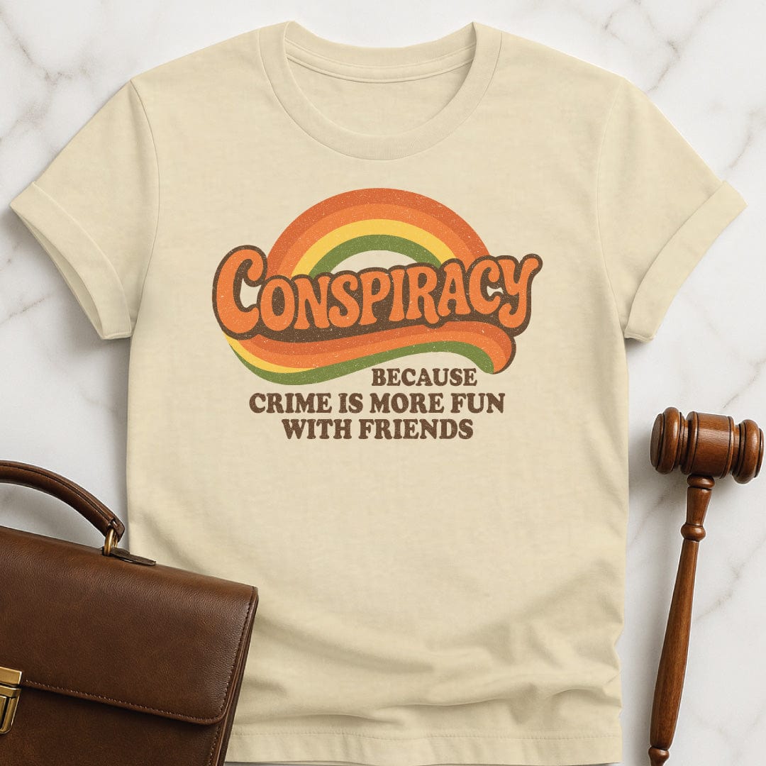 funny law school graphic tee that says Conspiracy because crime is more fun with friends featuring 70s retro vibe in cream