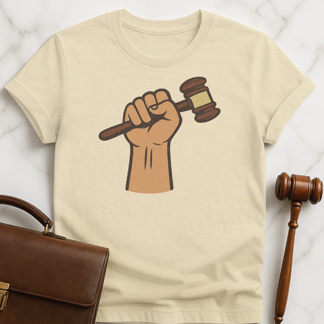 cool law school graphic tee featuring a fist holding a gavel in cream