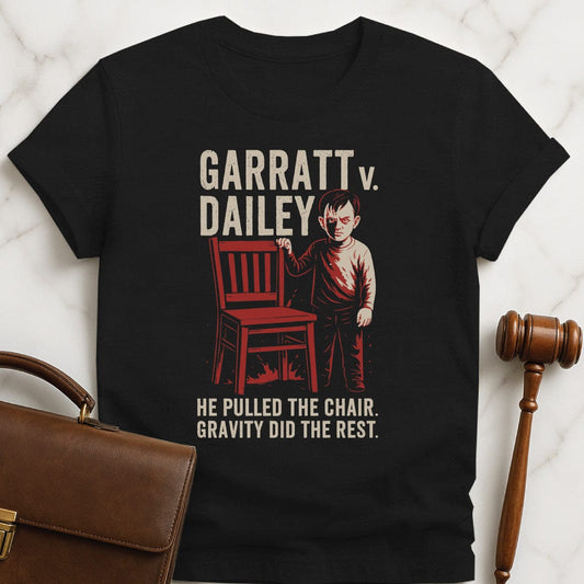 cool law grad graphic tee that says Garratt v Dailey He pulled the chair featuring scary boy pulling a chair in black