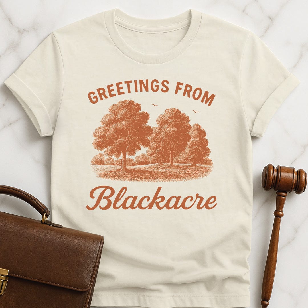 nerdy lawyer graphic t shirt that says greetings from blackacre featuring meadow with trees in cream