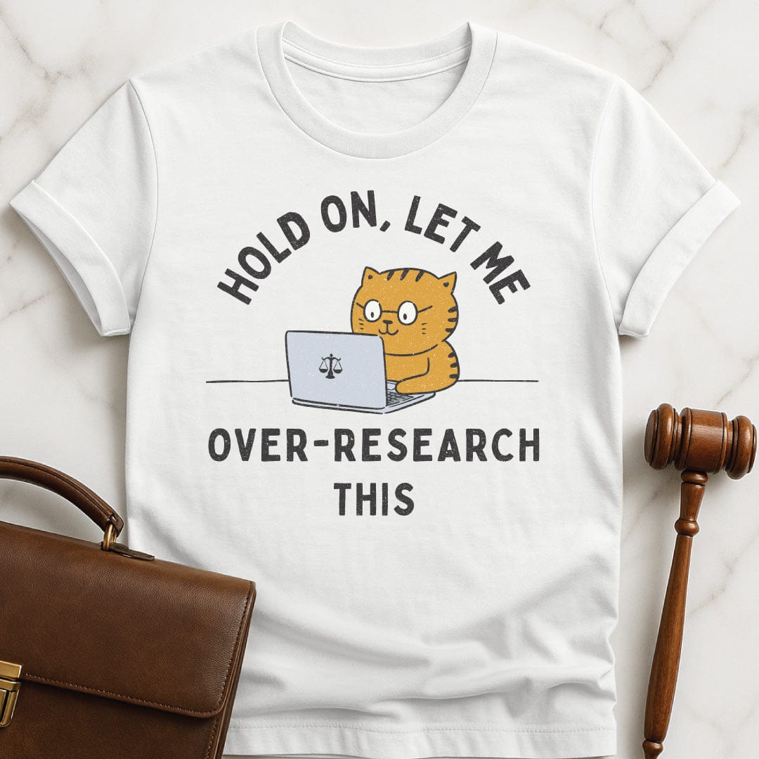 funny attorney t-shirt that says Hold On let me over research this featuring cat using a laptop with a scales of justice in white