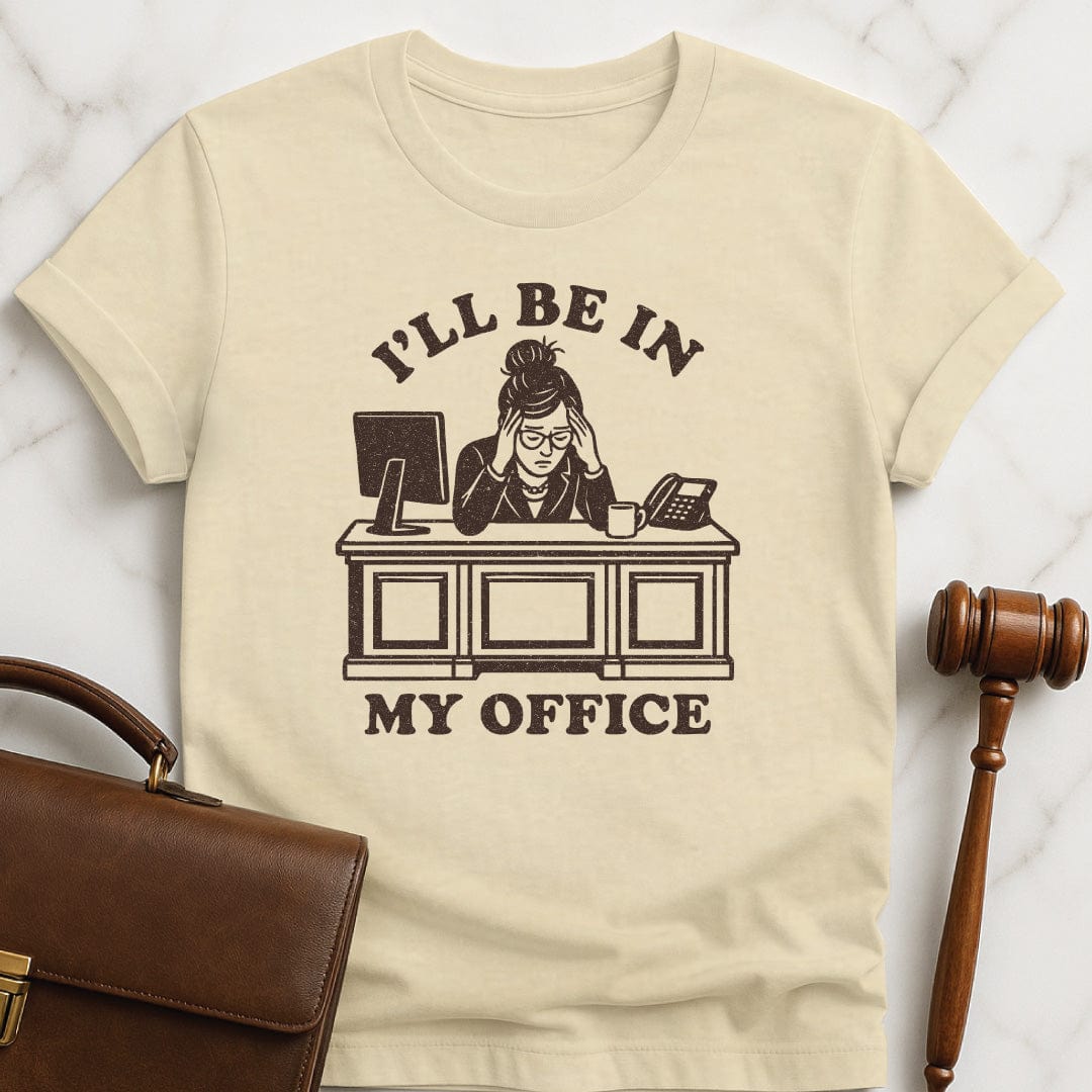cool law grad t shirt that says Ill be in my office featuring woman lawyer slumped over her desk looking stressed out in cream