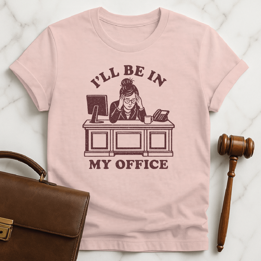 cool law school graduate tee that says Ill be in my office featuring woman lawyer slumped over her desk looking stressed out in pink