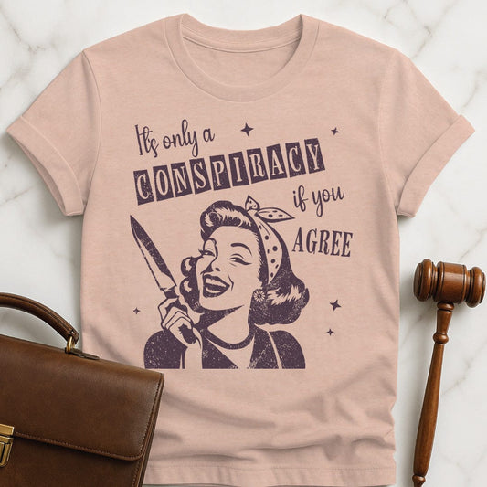 cool law student graphic t shirt that says its only a conspiracy if you disagree featuring a retro woman holding a knife in heather peach