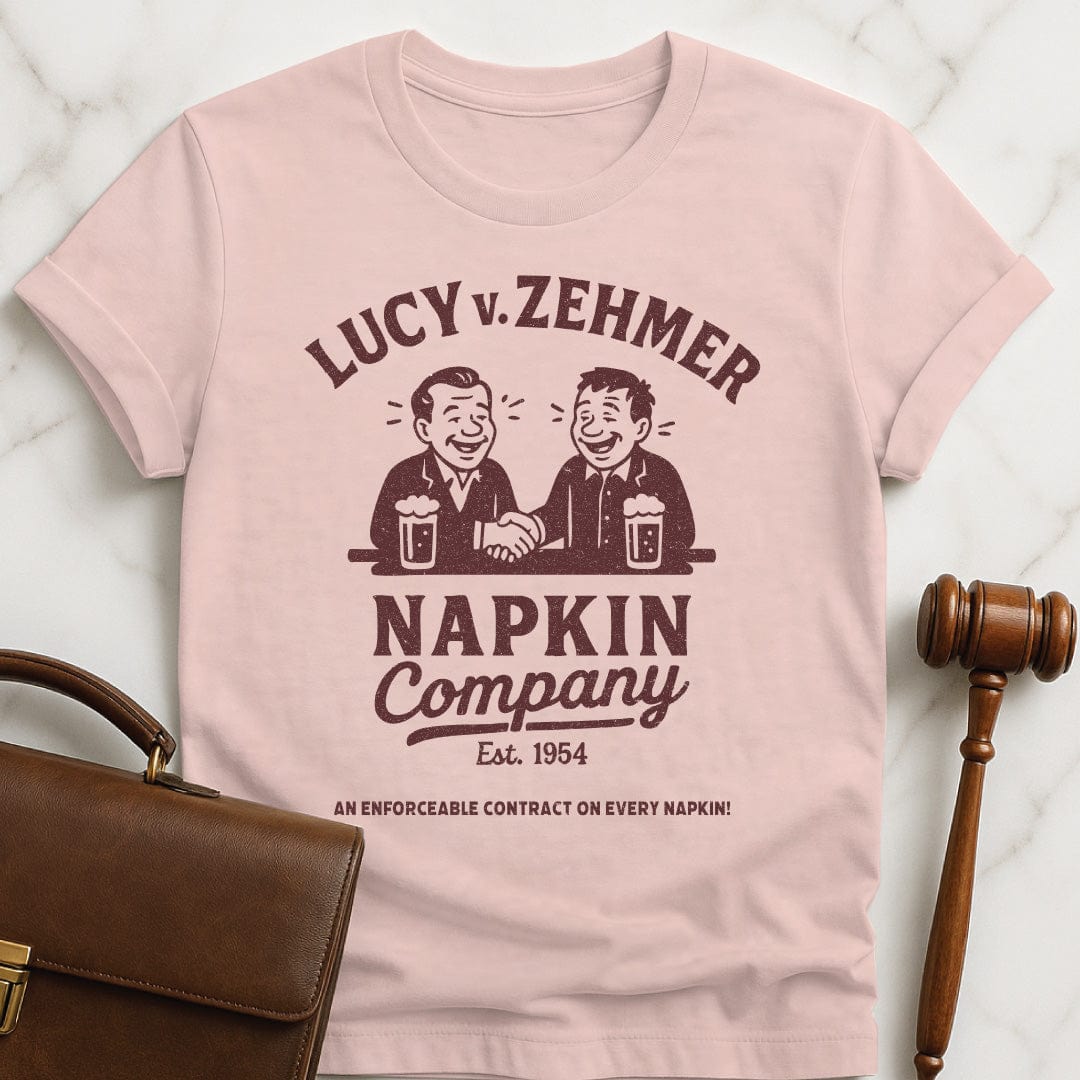 cool law school t shirt that says Lucy v Zehmer Napkin Company Est 1954 featuring two men drinking beer and shaking hands in pink