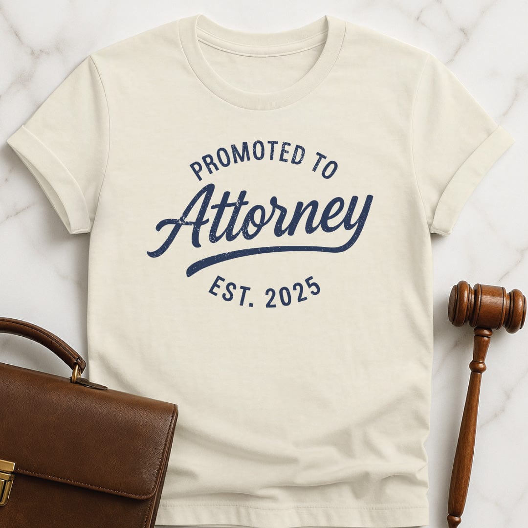 cute law school graphic tee that says Promoted to Attorney Established 2025 in cream