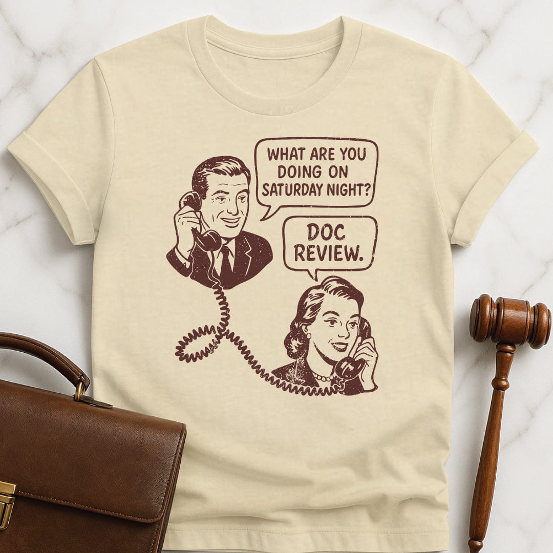 cool lawyer graphic tee featuring man asking a woman on the phone what are you doing Saturday night and she says doc review in cream
