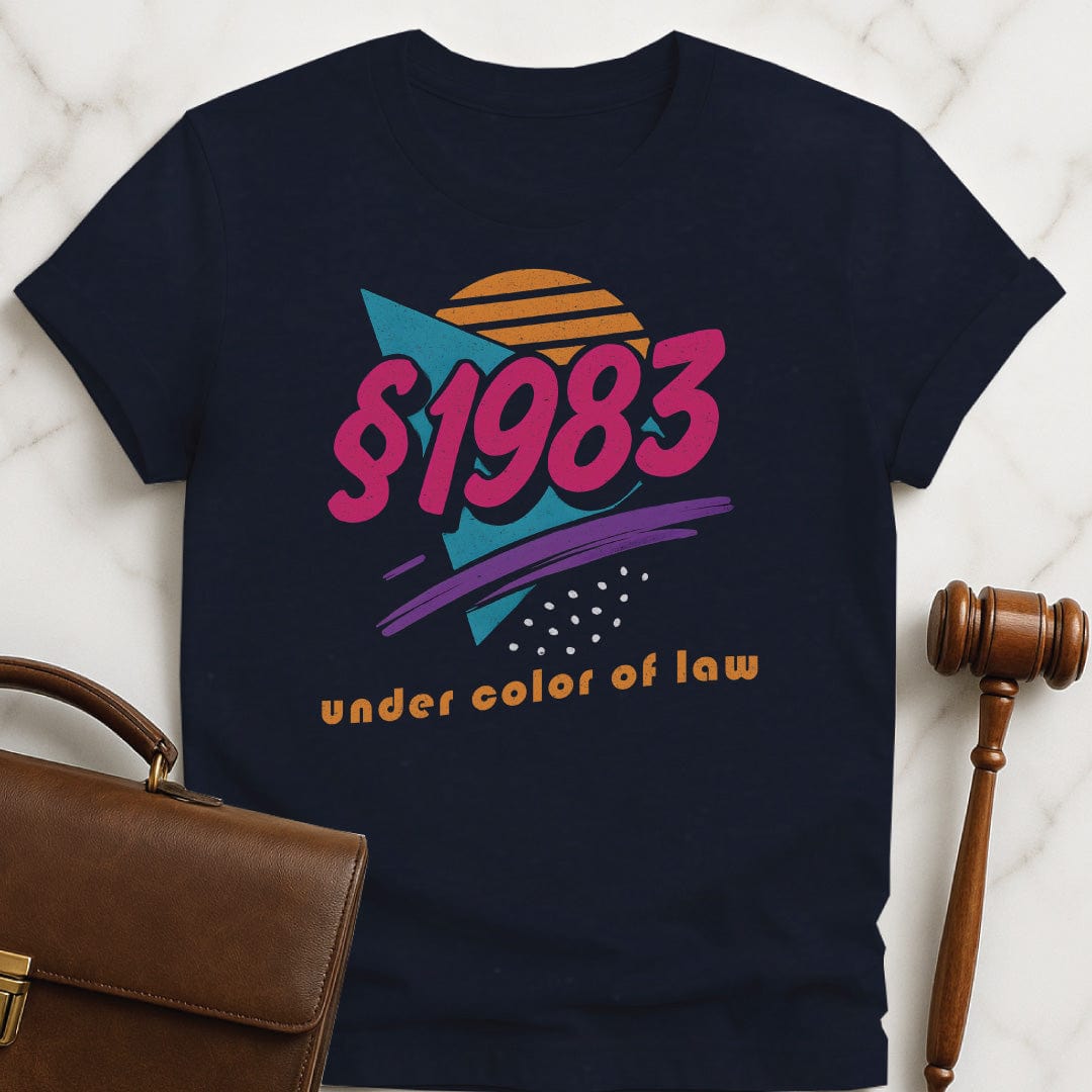 cool law school graphic t shirt that says section 1983 under color of law featuring 80s style font and graphics in blue