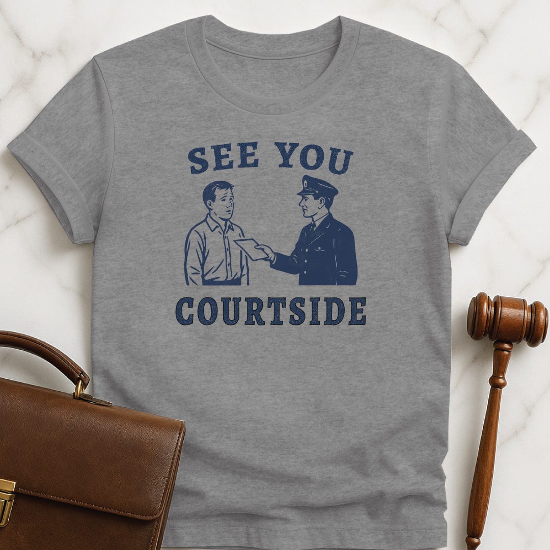 unique law school t shirt that says See You Courtside featuring police officer handing a person a piece of paper in grey