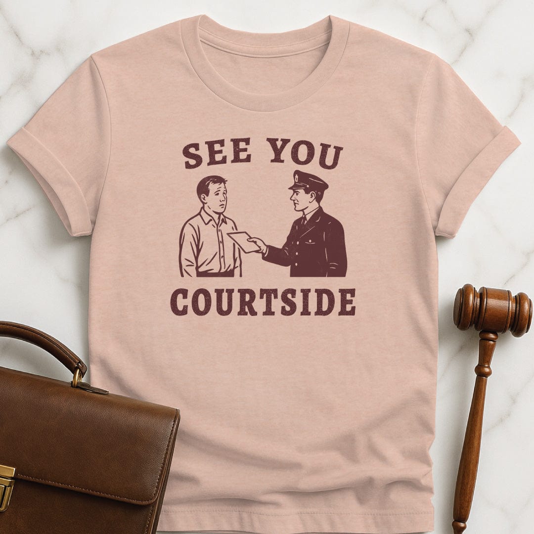 unique new lawyer graphic tee that says See You Courtside featuring police officer handing a person a piece of paper in heather peach