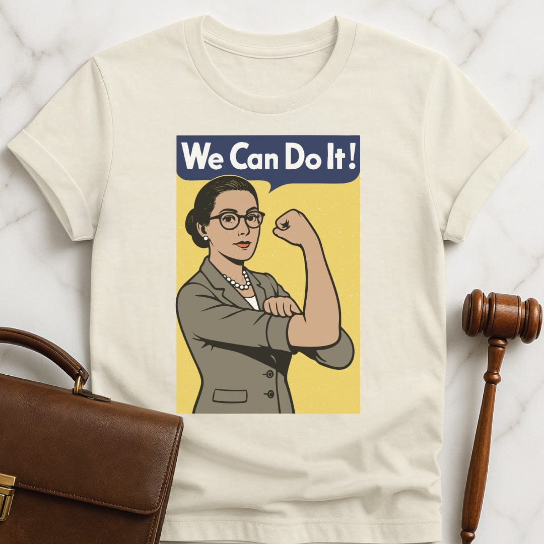 feminist law school graduate tee that says we can do it featuring a white woman in a business suit posing like Rosie the Riveter in cream