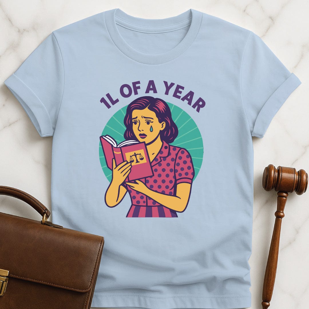 cool law school tee that says 1L of a Year featuring comic book woman holding a law textbook and crying in blue