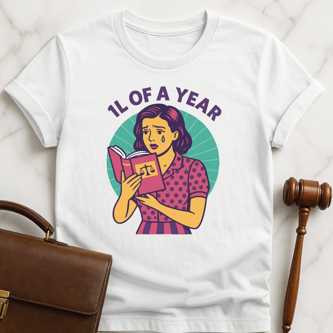 cool law school t shirt that says 1L of a Year featuring comic book woman holding a law textbook and crying in white