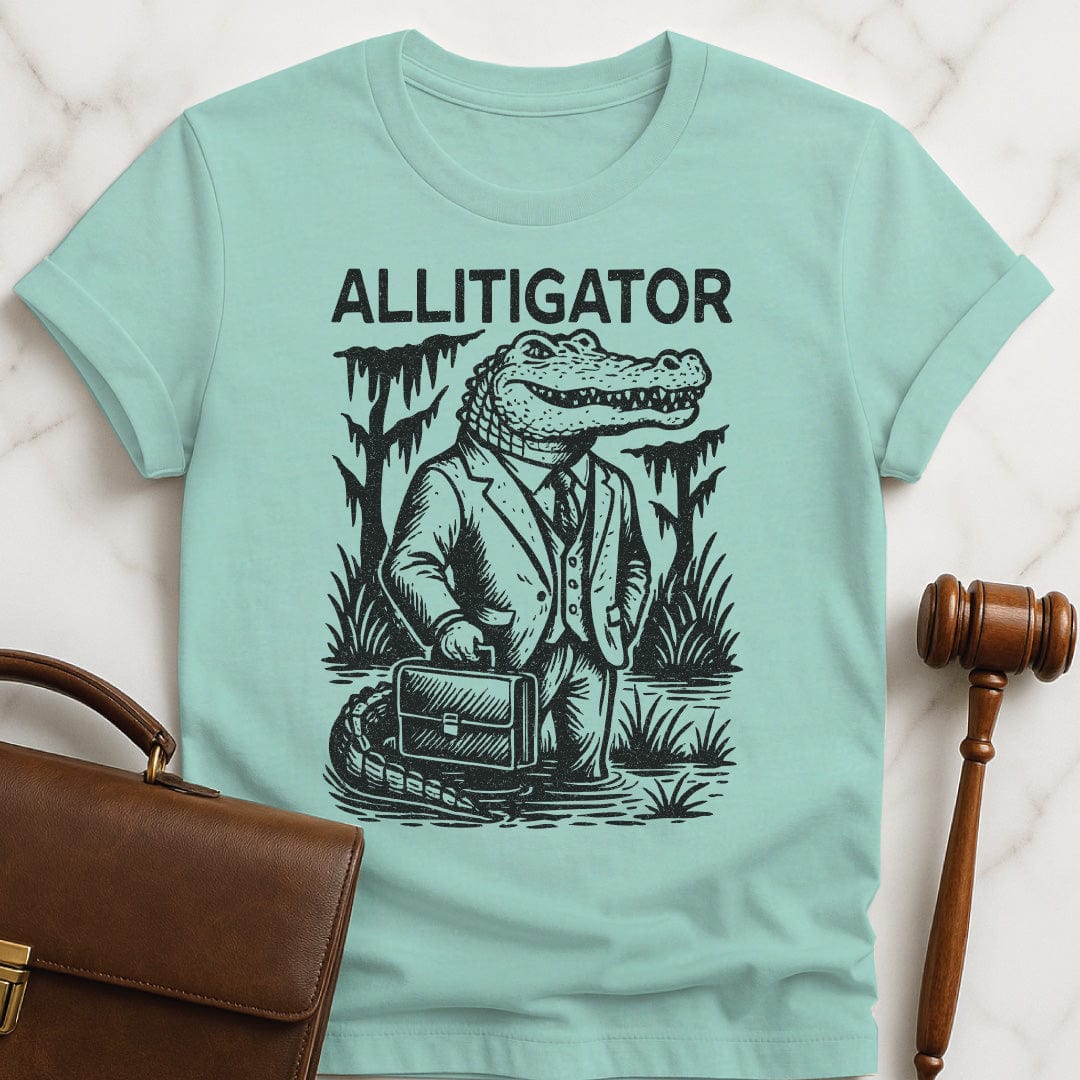 funny attorney graphic tshirt that says allitigator featuring an alligator holding a briefcase in a swamp in heather green