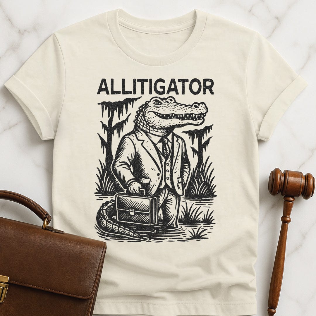 cute law grad t shirt that says allitigator featuring an alligator holding a briefcase in a swamp in cream