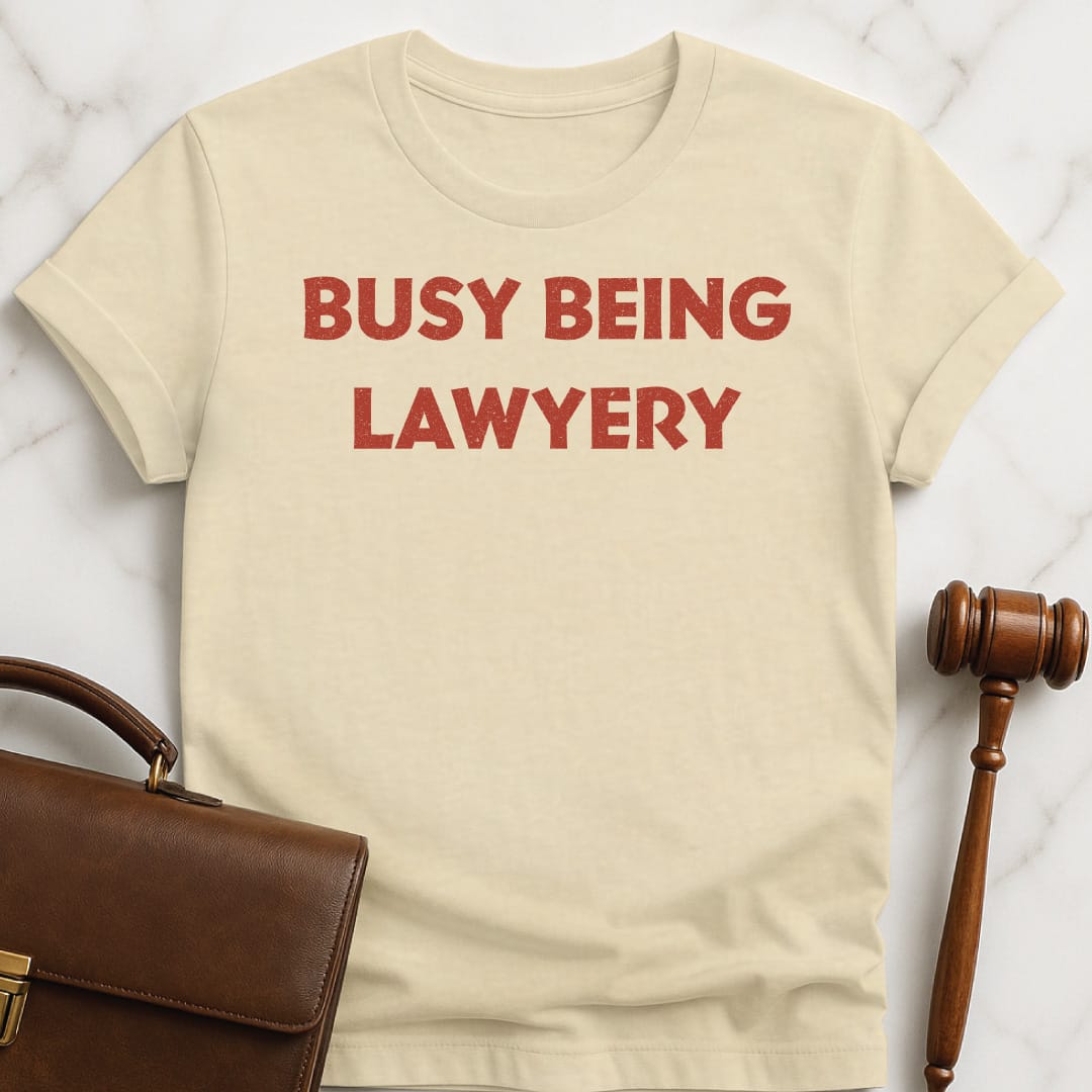 funny law grad graphic t-shirt that says Busy being lawyery featuring gift in cream