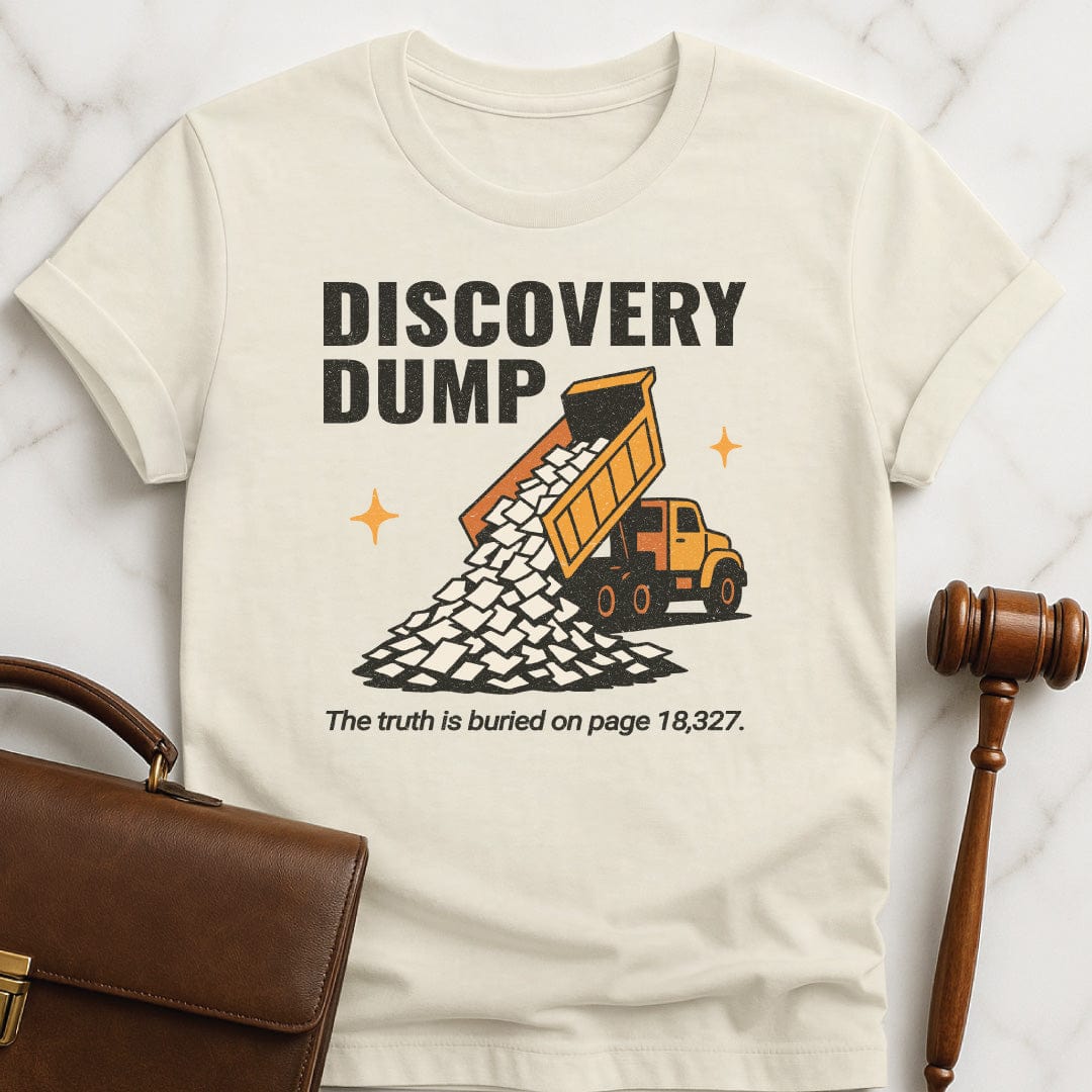 funny lawyer graphic tee that says Discovery Dump The truth is buried on page 18327 featuring dump truck pouring out papers in cream