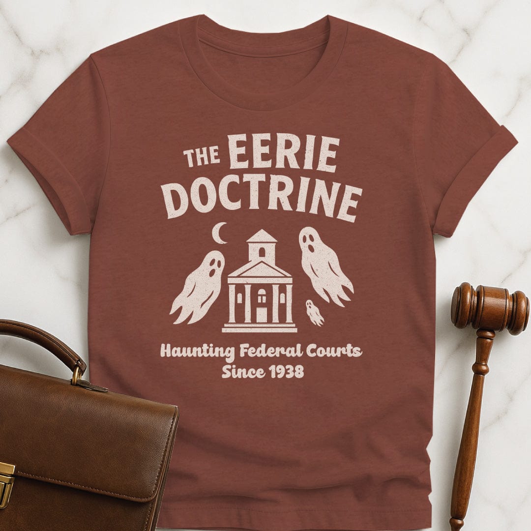 funny attorney t-shirt that says Eerie doctrine haunting federal courts since 1938 featuring ghosts and a courthouse in heather brown