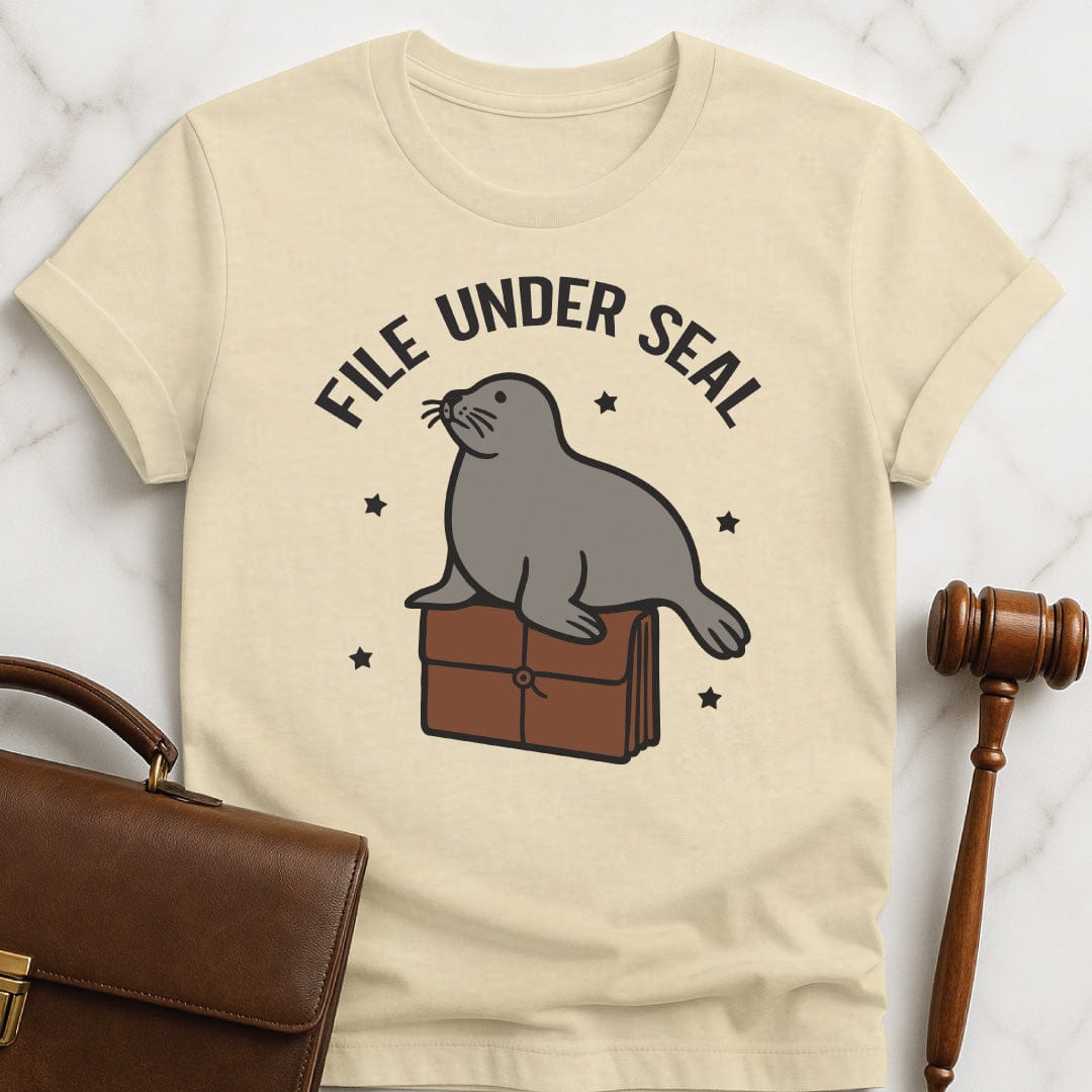 funny lawyer graphic t shirt that says file under seal featuring a seal sitting on top of a redwell in cream