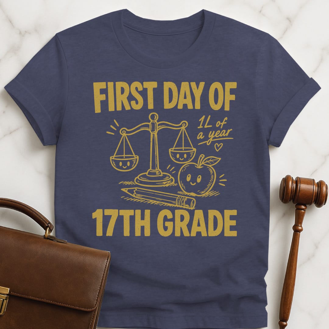 funny law school graphic t-shirt that says First Day of 17th Grade 1L of a year featuring apple scales of justice pencil and a heart in heather blue