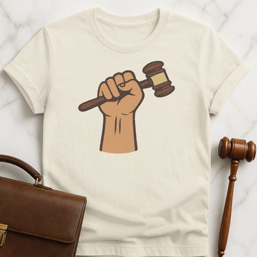 cool law school graduate t shirt featuring a fist holding a gavel in cream