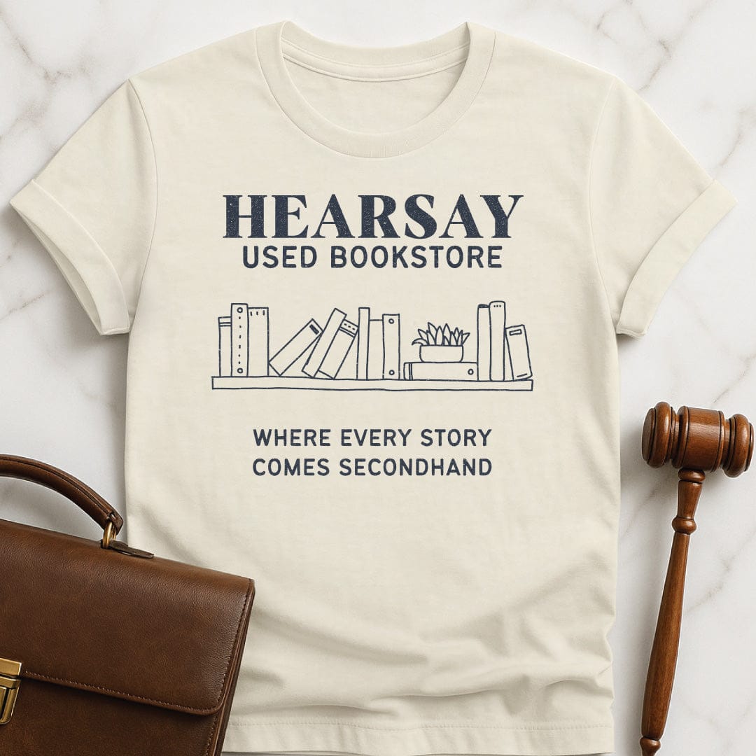 funny attorney graphic t-shirt that says hearsay used bookstore where all stories come secondhand featuring books in cream