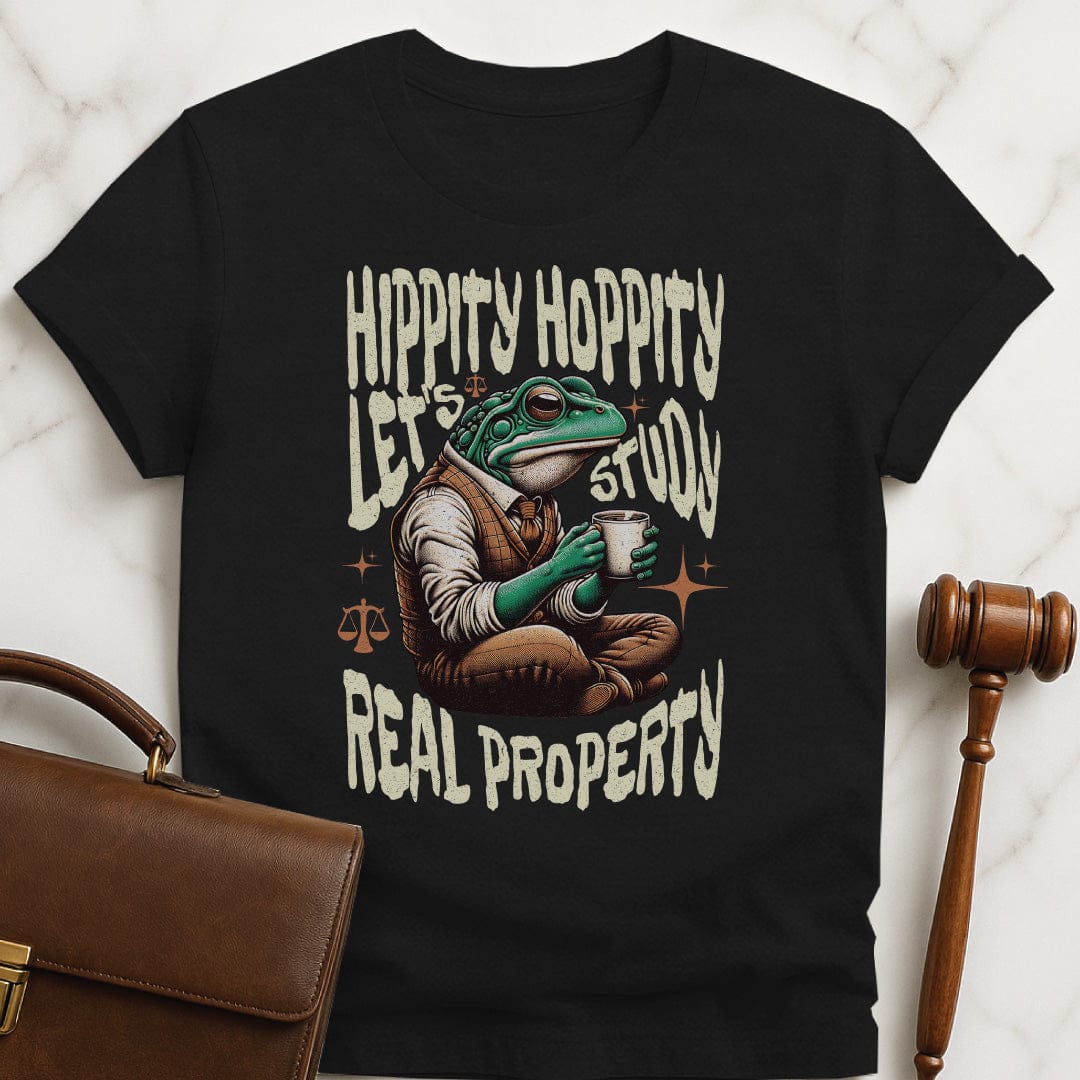 funny law school graphic t shirt that says Hippity Hoppity Lets Study Real Property featuring frog with scales of justice in black
