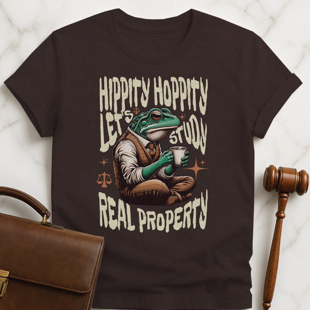 funny law school graduate t shirt that says Hippity Hoppity Lets Study Real Property featuring frog with scales of justice in brown