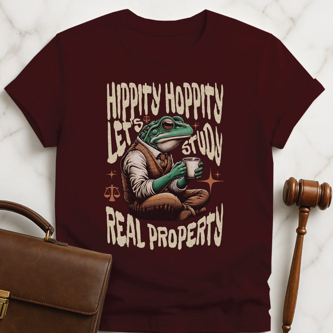 funny law grad graphic tee that says Hippity Hoppity Lets Study Real Property featuring frog with scales of justice in brown