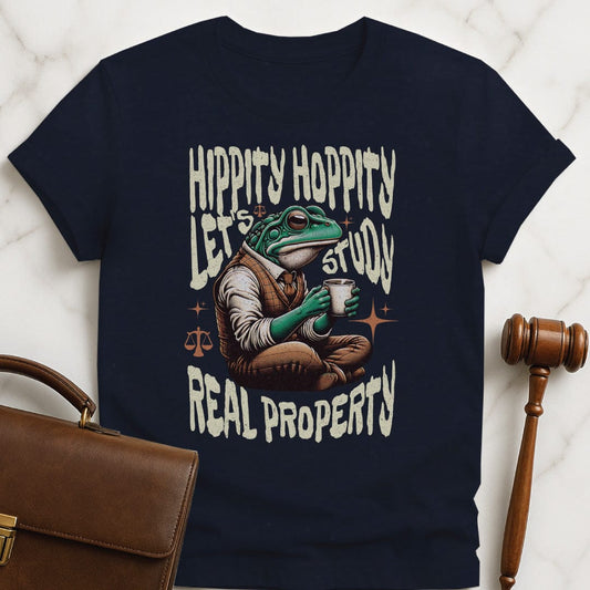 cool law school grad t-shirt that says Hippity Hoppity Lets Study Real Property featuring frog with scales of justice in blue