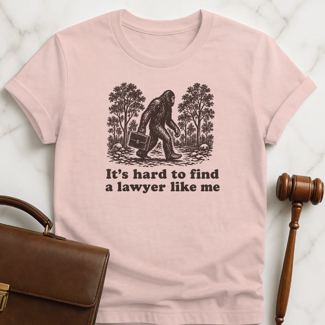 cool law graduate graphic tee that says its hard to find a lawyer like me featuring big foot in pink
