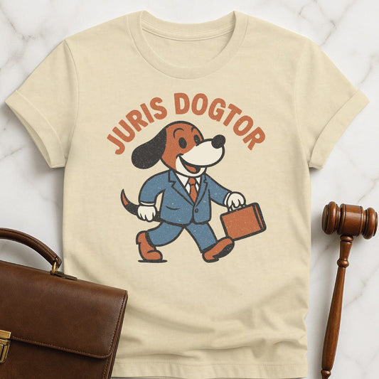 funny new attorney graphic tshirt that says juris dogtor featuring a cute vintage dog in a suit and carrying a briefcase in cream