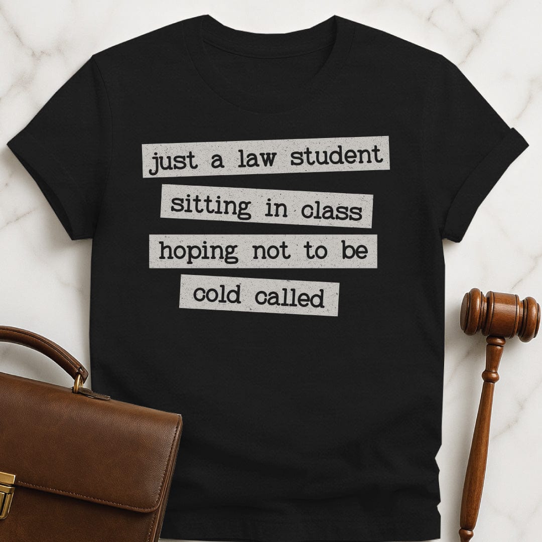 cool law school graphic t shirt that says just a law student sitting in class in black
