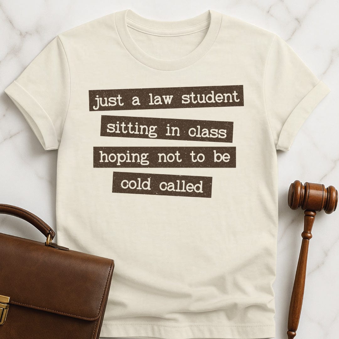 funny law student graphic t-shirt that says just a law student sitting in class in cream