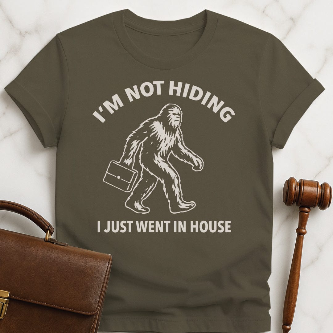 funny attorney t-shirt that says Im not hiding I just went in house featuring Bigfoot carrying a briefcase in green