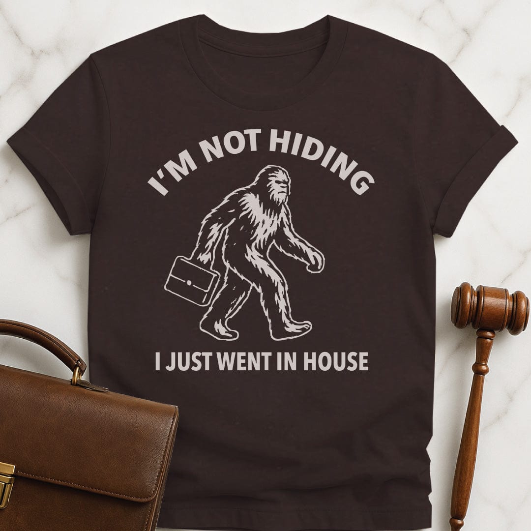 funny attorney graphic t-shirt that says Im not hiding I just went in house featuring Bigfoot carrying a briefcase in brown