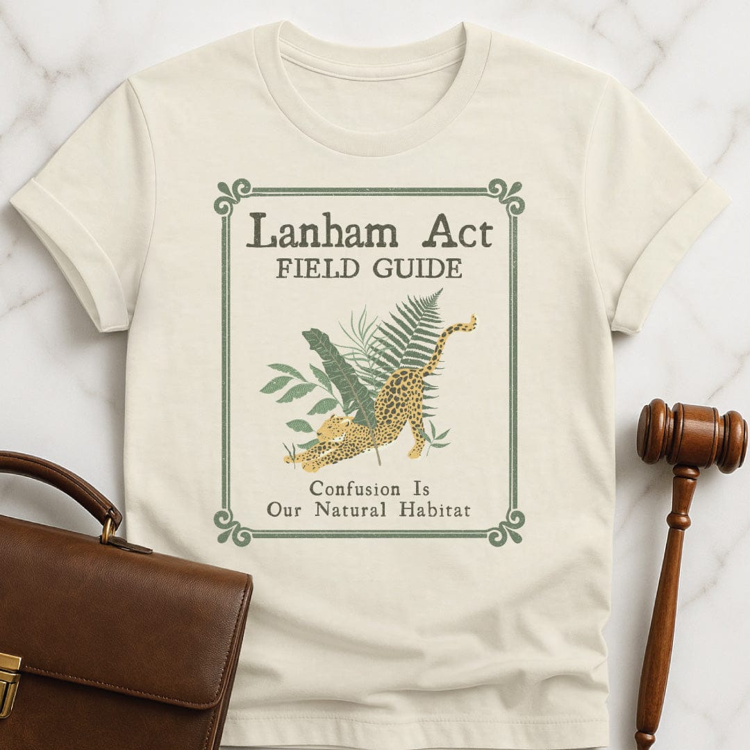 funny attorney graphic tshirt that says Lanham Act Field Guide confusion is our natural habitat featuring cheetah in the jungle in cream