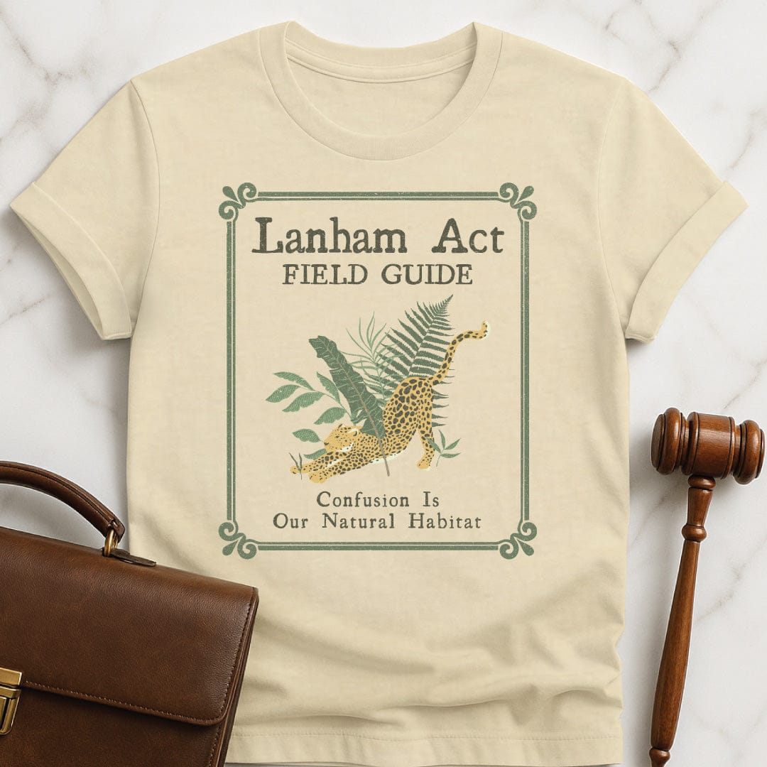 funny attorney graphic t-shirt that says Lanham Act Field Guide confusion is our natural habitat featuring cheetah in the jungle in cream