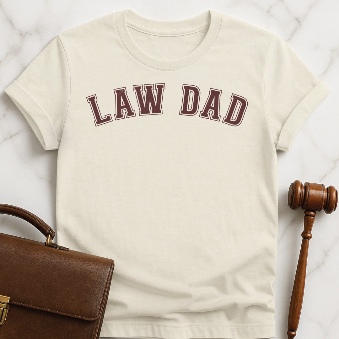 father law school graduate tee that says Law Dad in cream