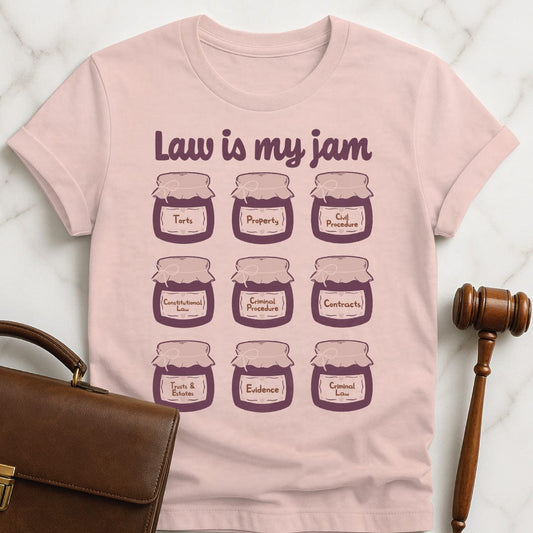 cute law school grad tshirt that says law is my jam featuring jars of purple jam saying torts property civil procedure constitutional law criminal procedure contracts trusts and estates evidence criminal law in pink