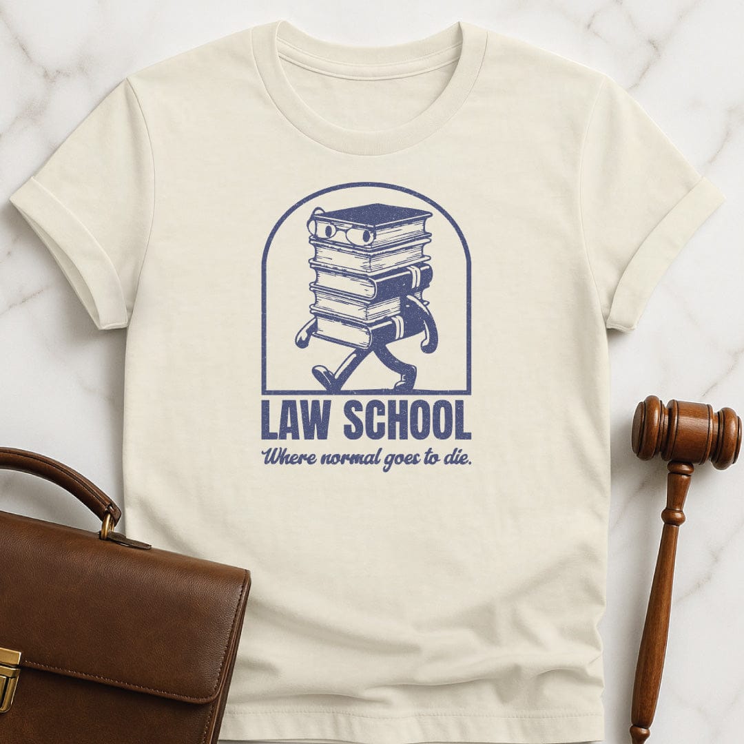 funny law school grad t-shirt that says Law School Where Normal Goes to Die featuring pile of books with a face in cream