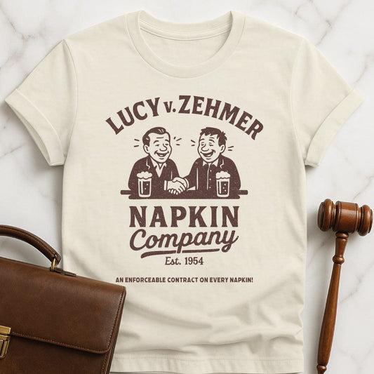 cool law school t shirt that says Lucy v Zehmer Napkin Company Est 1954 featuring two men drinking beer and shaking hands in cream