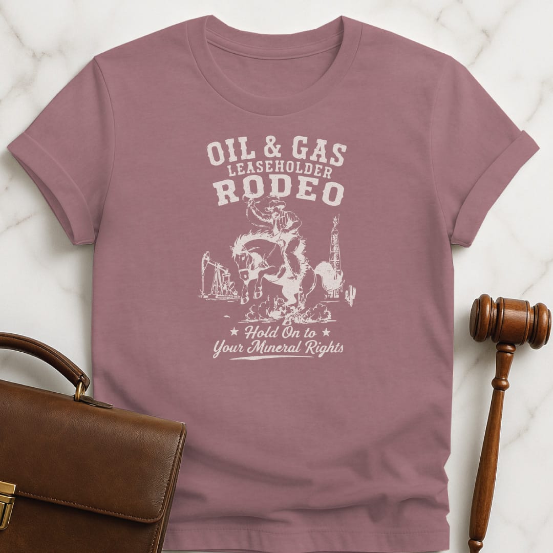 funny attorney graphic t-shirt that says oil and gas leaseholder rodeo hold onto your mineral rights featuring cowboy on a horse at a rodeo with oil and gas in background in heather mauve