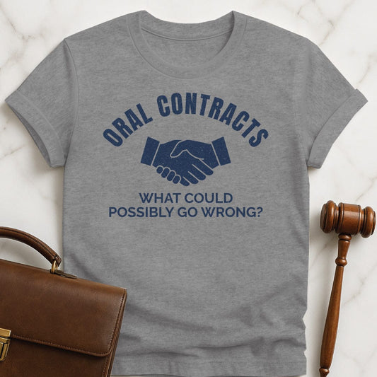 funny law student graphic tshirt that says Oral Contracts what could possibly go wrong featuring handshake in grey