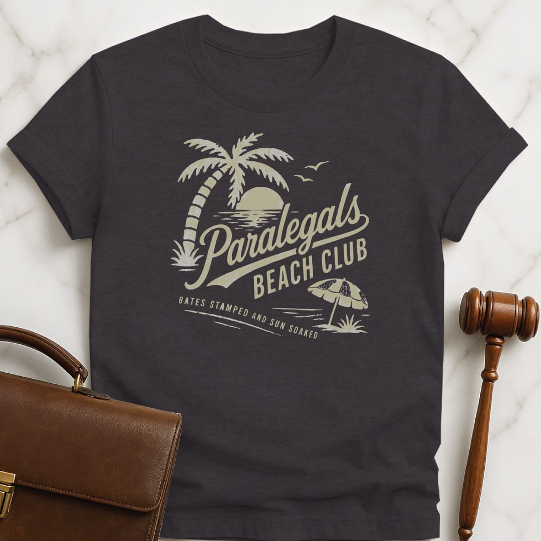 funny lawyer graphic tshirt that says paralegals beach club bates stamped and sun soaked featuring beach scene in black