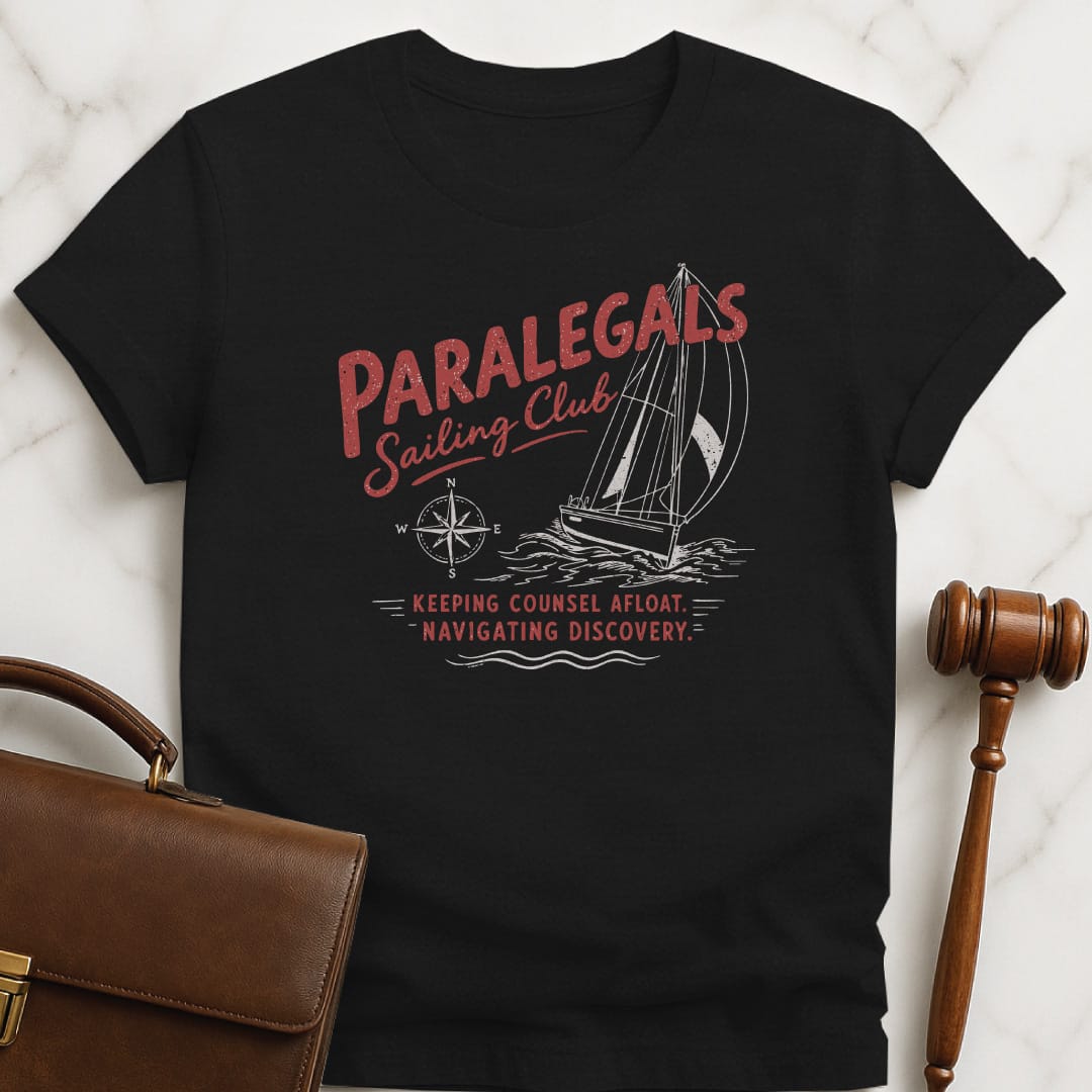 funny lawyer graphic t-shirt that says paralegals sailing club navigating discovery keeping counsel afloat featuring boat in black