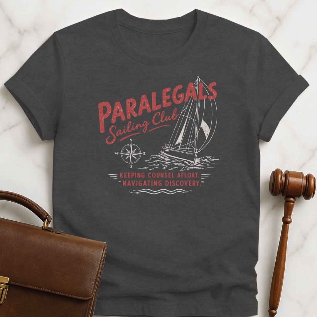 cool attorney graphic t shirt that says paralegals sailing club navigating discovery keeping counsel afloat featuring boat in grey