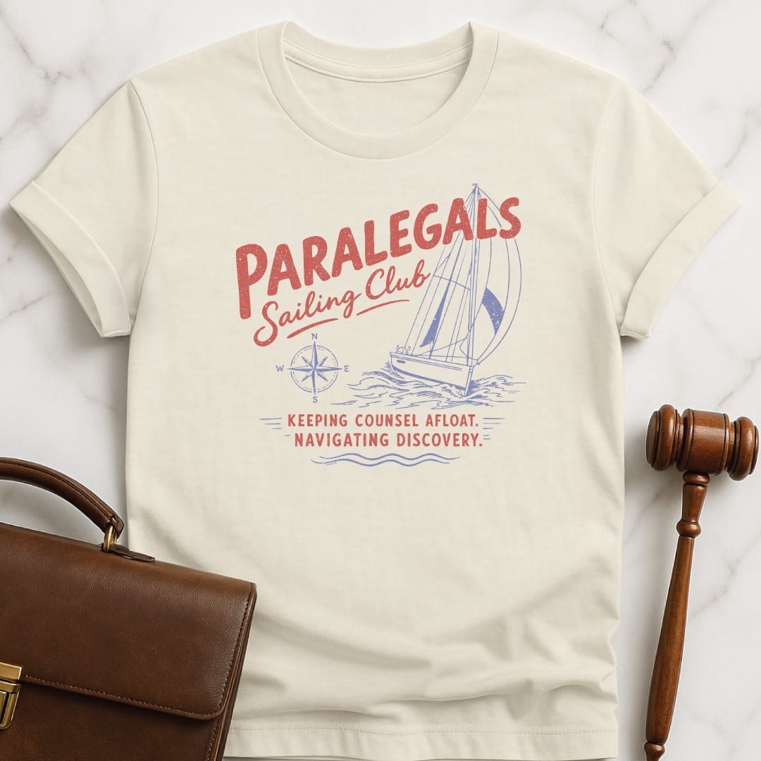 funny lawyer graphic tshirt that says paralegals sailing club navigating discovery keeping counsel afloat featuring boat in cream