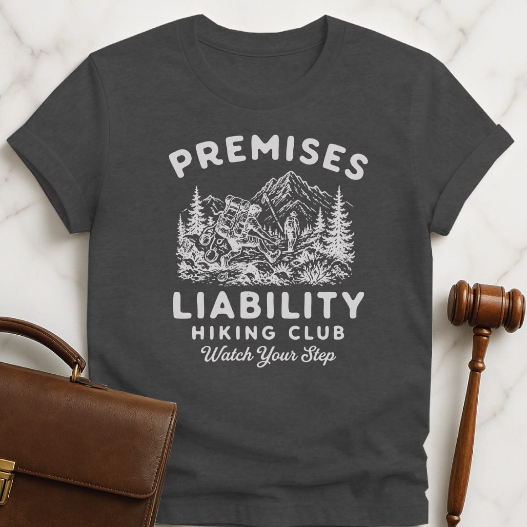 funny law school grad graphic t-shirt that says premises liability hiking club watch your step featuring a hiker falling in grey
